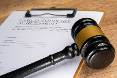 A gavel on a child support agreement document | Law Offices of Andrea Schneider
