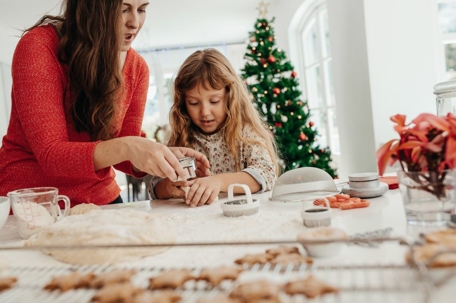 mom and daughter baking cookies