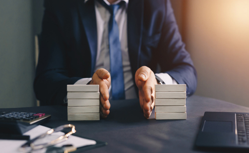 Businessman separates wooden block. Property division. Divorce and legal services.